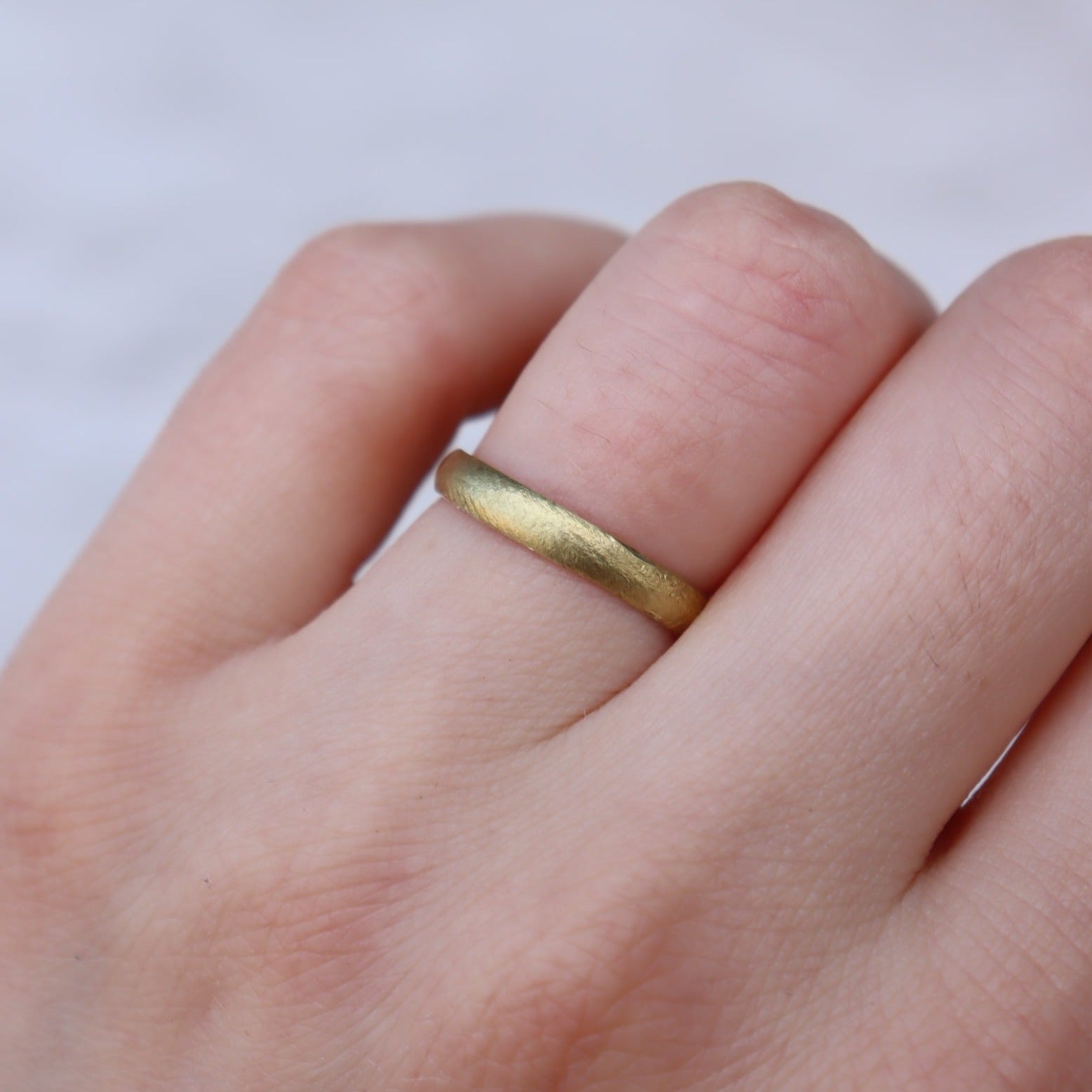 A timeless wedding band that features the makers finger prints around the surface of the band. The band sits flush to the skin, making it the perfect option for low set engagement rings