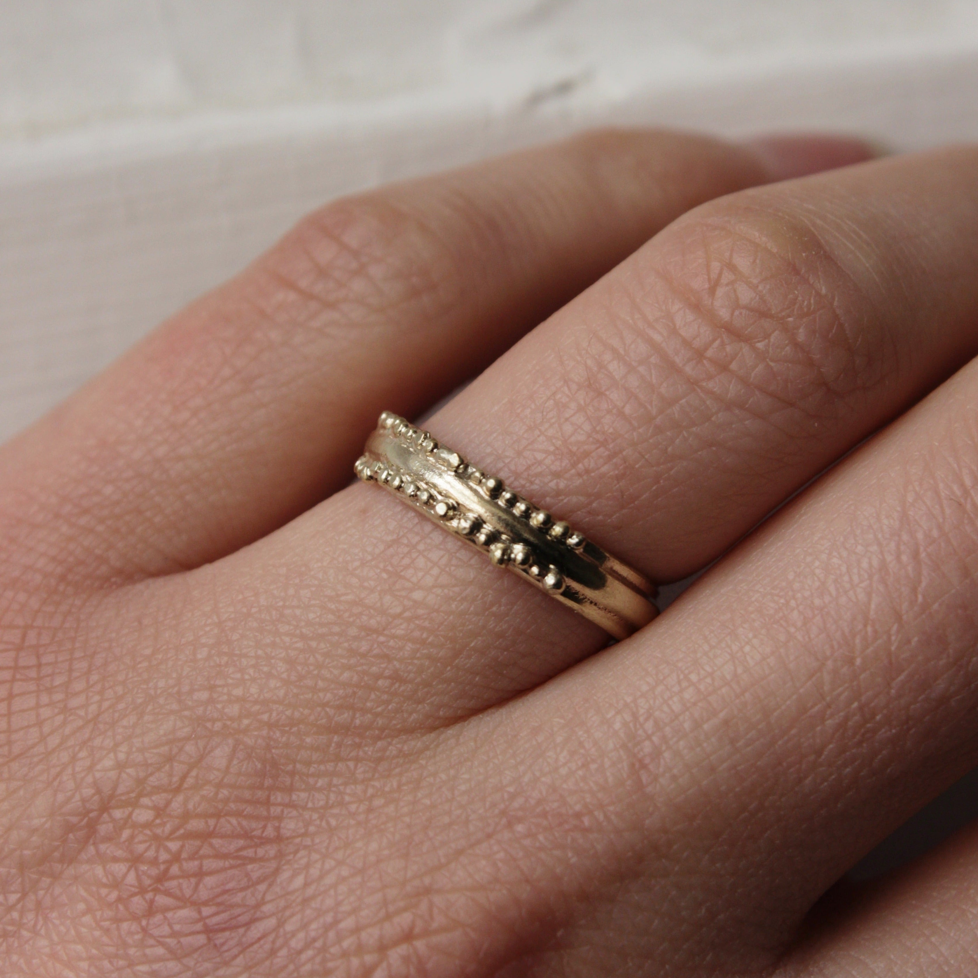 This stunning wedding ring is perfect for the alternative bride looking for an extra special wedding band. Inspired by ancestral metalsmithing techniques, this ring featured delicate granulation details that capture the light beautifully.