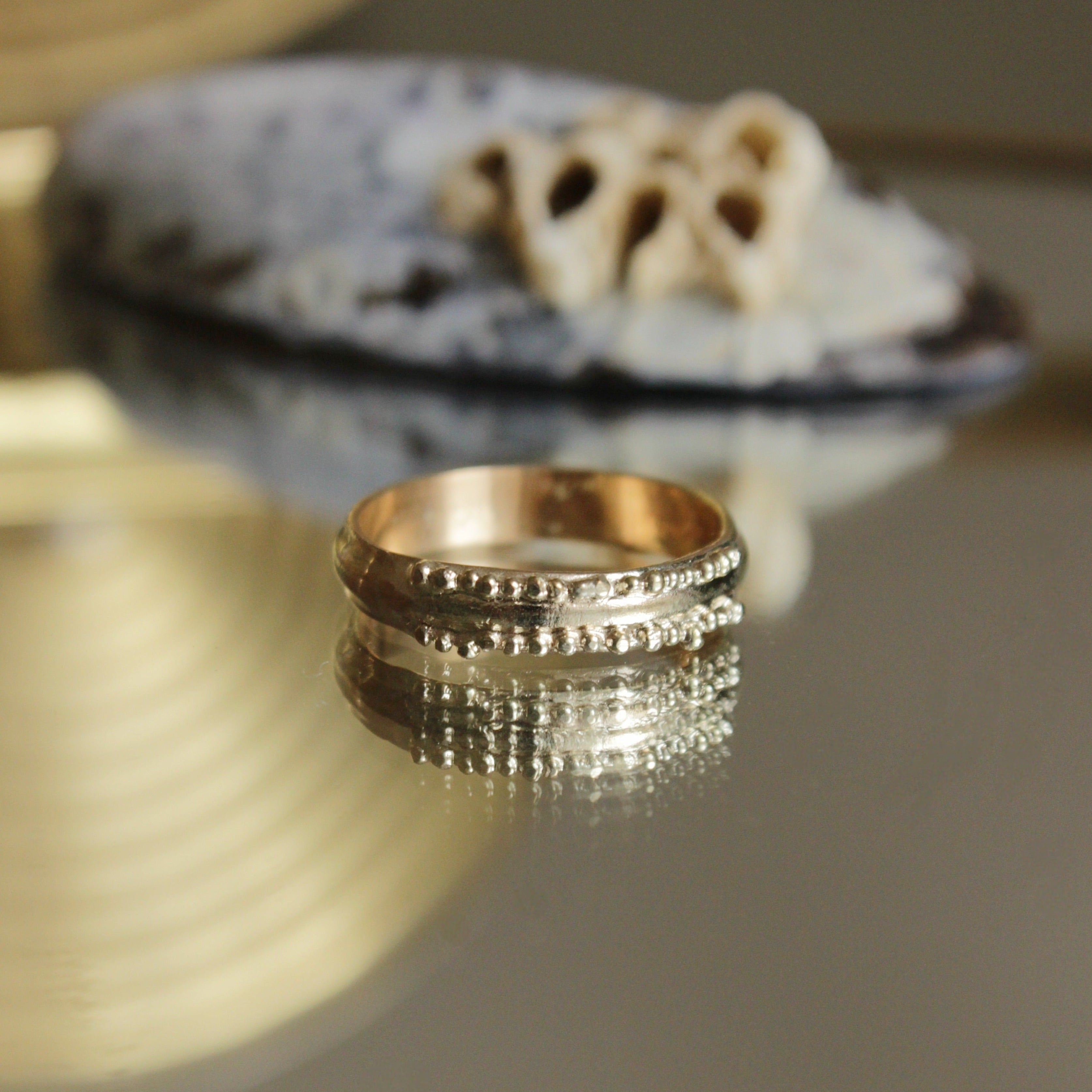 This stunning wedding ring is perfect for the alternative bride looking for an extra special wedding band. Inspired by ancestral metalsmithing techniques, this ring featured delicate granulation details that capture the light beautifully.